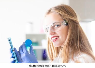 young student learning a scientific trial in a laboratory - Shutterstock ID 1866159997