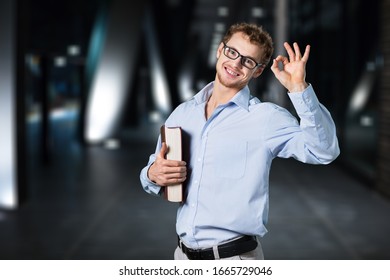 Young student man in glasses with book - Shutterstock ID 1665729046