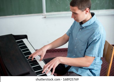 Young student performing playing on piano in classroom