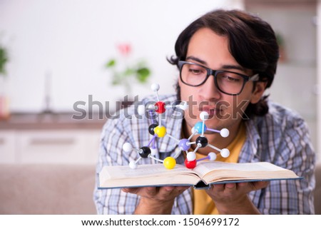 Young student physicist preparing for exam at home