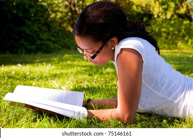Young Student reading books at  school park