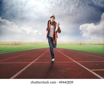 Young Student Running On A Racing Track