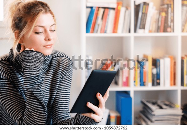 Young Student Using Ebook Bookshelf On Stock Image Download Now