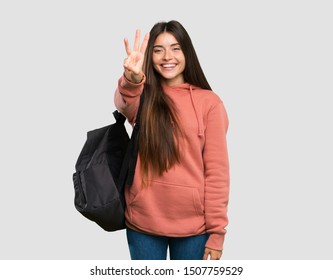 Young Student Woman Holding Notebooks Happy And Counting Three With Fingers Over Isolated Grey Background