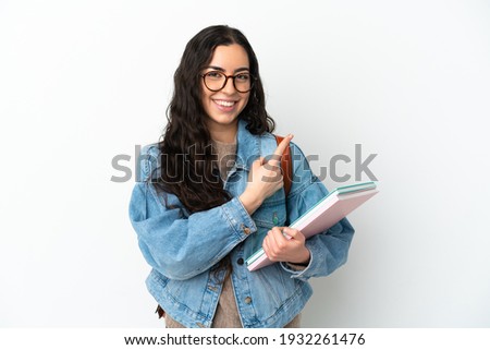 Young student woman isolated on white background pointing to the side to present a product