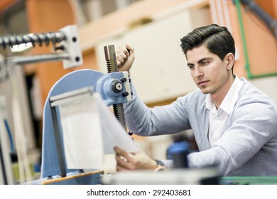 Young Student Working On A Science Project On A Machine