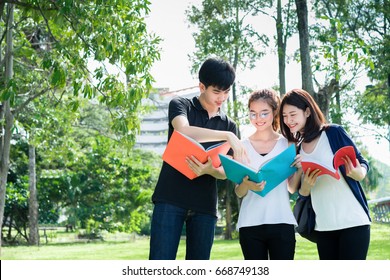 Young Students Asian Together Group Teenager Smile With Laptop Computer, School Folders Reading Book At High School University Campus College Knowledge Center For Study Learning In Summer Outdoor.