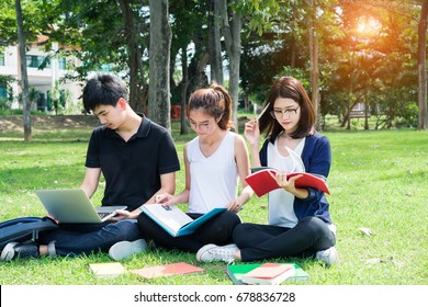 Young Students Asian Together Group Teenager Smile With Laptop Computer, School Folders Reading Book At High School University Campus College Knowledge Center For Study Learning In Summer Outdoor.