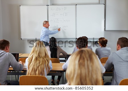 Young students in class at economic studies at university