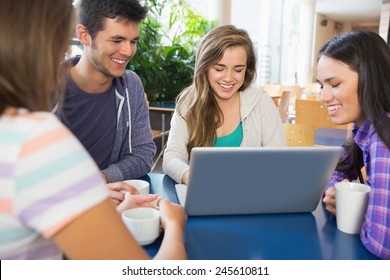 Young students doing assignment on laptop together at the university - Shutterstock ID 245610811