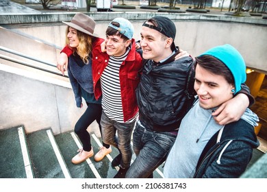 Young Students Group Walking Up Stairs At City Center - Next Gen Life Style Concept On Multicultural Young People Wearing Winter Fashion Clothes Having Fun Together Outdoors - Bright Vivid Filter