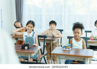 Young students learning in science class room. Group of diverse children are enjoy learning in STEM classroom. STEM stand for science, technology, engineering, and mathematics.