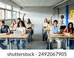 Young students raising hands to ask a question during lecture at high school classroom. Education and back to school concept.