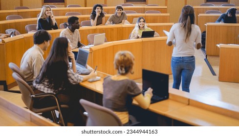 Young students working with laptop computers inside classroom at school university - College, back to school and campus lifestyle concept  Focus on top students
