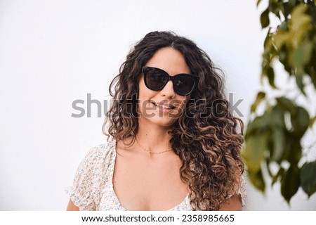 Similar – Woman with sunglasses looking at camera over garden fence