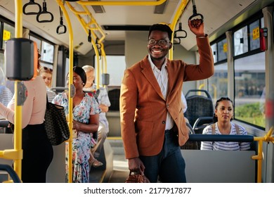 A young stylish african american businessman is smiling while riding the bus - Powered by Shutterstock