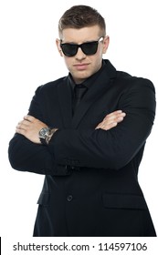 Young Stylish Bouncer In A Black Suit, Arms Folded. Half Length Portrait