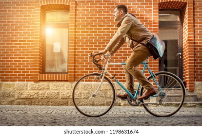 Young Stylish Businessman Go To Work On His Sport Retro Bike In Sunny Day.