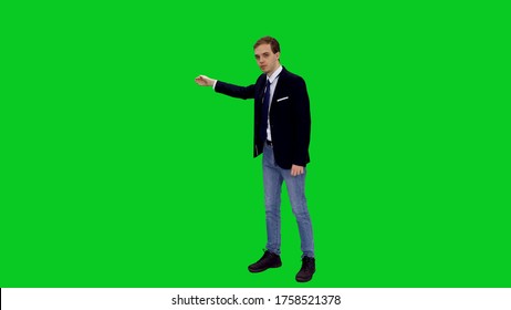 Young stylish businessman in suit jacket standing and presenting something on green screen background - Powered by Shutterstock