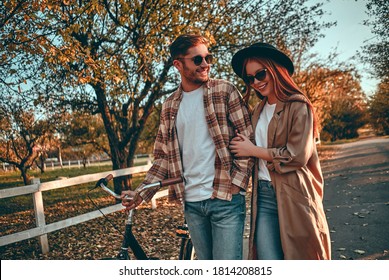 Young Stylish Couple, With Bicycles, In The Park In Autumn.