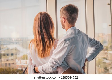 Young Stylish Couple Embrace Modern Apartment Big Panoramic Window city View, Mix Race Man And Woman Morning Home Interior - Powered by Shutterstock