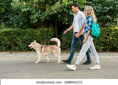 Young Stylish Couple Walking With Dog In Street, Man And Woman Happy Together, Husky Breed, Summer Season, Denim Casual Style