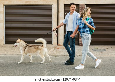 Young Stylish Couple Walking With Dog In Street, Man And Woman Happy Together, Husky Breed, Summer Season, Denim Casual Style