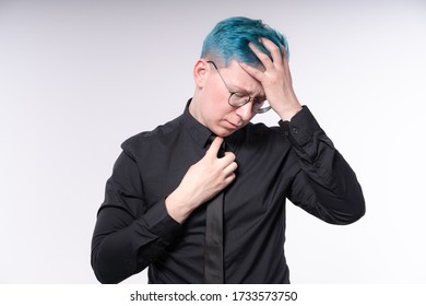 Young Stylish European Man Adjusts His Bright Blue Hair And Skinny Tie, Waist Deep Photo In A Studio