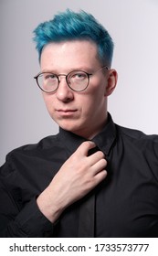 Young Stylish European Man With Blue Hair Adjusts His Skinny Tie, Studio Portrait