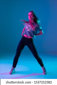 Young Stylish Girl Dancing Zumba In The Studio On A Colored Neon Background. Dance Poster Design.