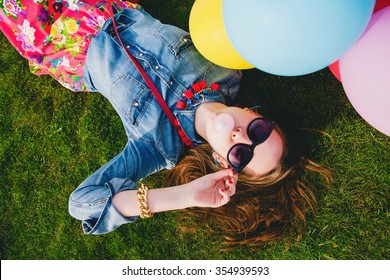 Young Stylish Hipster Teen Girl Happy, Bubblegum, Lying On Grass In Park, Air Balloons Birthday Party, Cool Accessories, Sunglasses, Colorful, Having Fun, Denim Shirt, Fashion Trend Summer Outfit