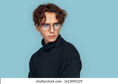 Young stylish man wearing eyeglasses standing isolated on gray background looking aside curious close-up - Powered by Shutterstock