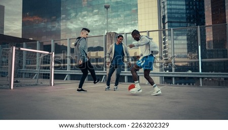 Young Stylish People Playing Soccer on a Rooftop Around Modern City Skyscrapers. Young Football Player Dribbling, Showing Off Tricks and Dodging Opponents