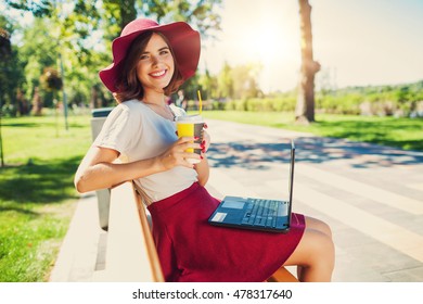 Young Stylish Pretty Woman Using Laptop Outside