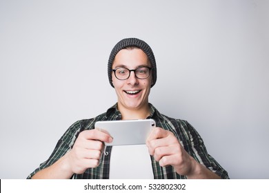 Young Stylish Smiling Guy Is Watching Funny Video On His Mobile Phone. He Is Happy Because Of Seen Movie