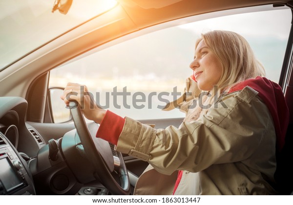 Young stylish woman driving car. Travel,\
Holidays, Journey, Trip, Lifestyle concept. Health care,\
authenticity, sense of balance and\
calmness.