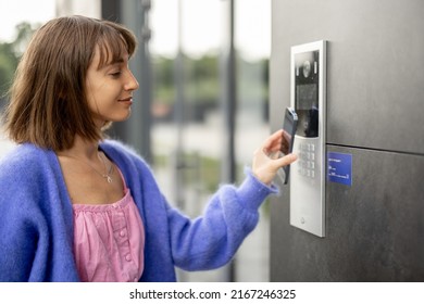 Young stylish woman getting access to the building by attaching smartphone to intercom. Concept of modern security technologies for access and smart home - Shutterstock ID 2167246325