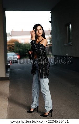 Young stylish woman Portrait woman in jeans on street