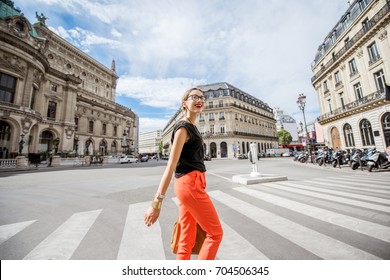 Young stylish woman in red pants crossing the street in Paris - Powered by Shutterstock