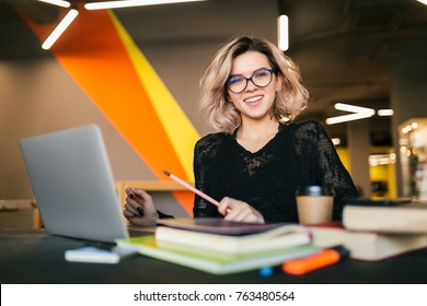 Young Stylish Woman Sitting At Table In Co-working Office, Studying, Work Place, Working On Laptop, Smiling, Happy, Positive Emotion