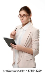 Young Stylish Woman Standing Holding A Notepad And A Pen.