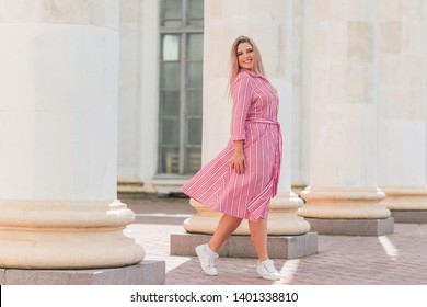 Young Stylish Woman Walking On The City Street At Summer. Casual Fashion, Linen Dress Look. Plus Size Model. Happy Overweight Woman Walking The City Streets