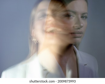 Young Stylish Woman In A White Jacket, Distortions Of The Model's Face On A Long Exposure. Second Personality, Alter Ego Concept