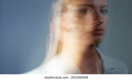 Young Stylish Woman In A White Jacket, Distortions Of The Model's Face On A Long Exposure. Second Personality, Alter Ego Concept