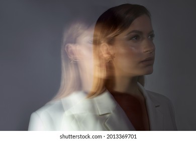 Young Stylish Woman In A White Jacket, Distortions Of The Model's Face On A Long Exposure. Second Personality, Alter Ego Concept