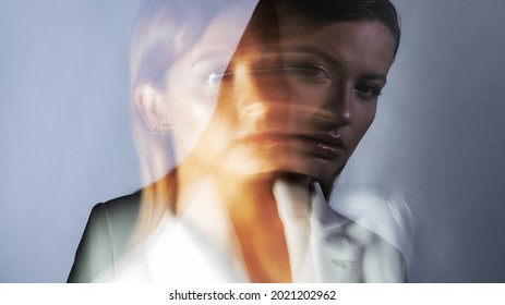 Young Stylish Woman In A White Jacket, Distortions Of The Model's Face On A Long Exposure. Second Personality, Alter Ego Concept