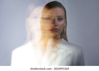 Young Stylish Woman In A White Jacket, Distortions Of The Model's Face On A Long Exposure. Second Personality, Alter Ego Concept