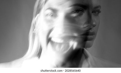 Young Stylish Woman In A White Jacket, Distortions Of The Model's Face On A Long Exposure. Second Personality, Alter Ego Concept