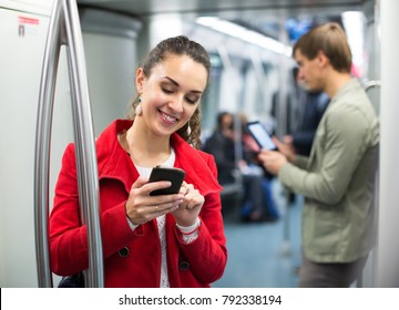 Young Subway Passengers Busy With  Phones And Tablet