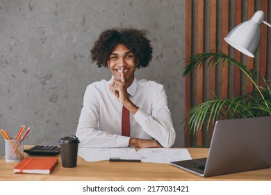 Young Successful African American Employee Business Man In Classic Shirt Tie Say Hush Be Quiet With Finger On Lips Shhh Gesture Sit Work At White Office Desk With Pc Laptop Achievement Career Concept